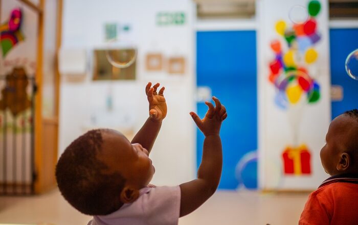 baby reaching up into the air